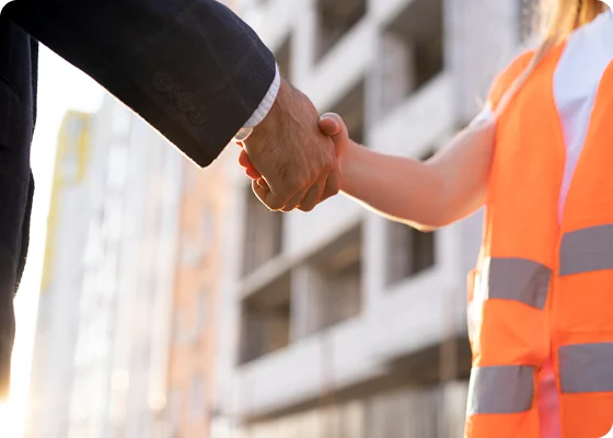 A successful partnership handshake between a Pixerts digital growth consultant and an industrial leader, representing the close of a manufacturing RFQ deal.