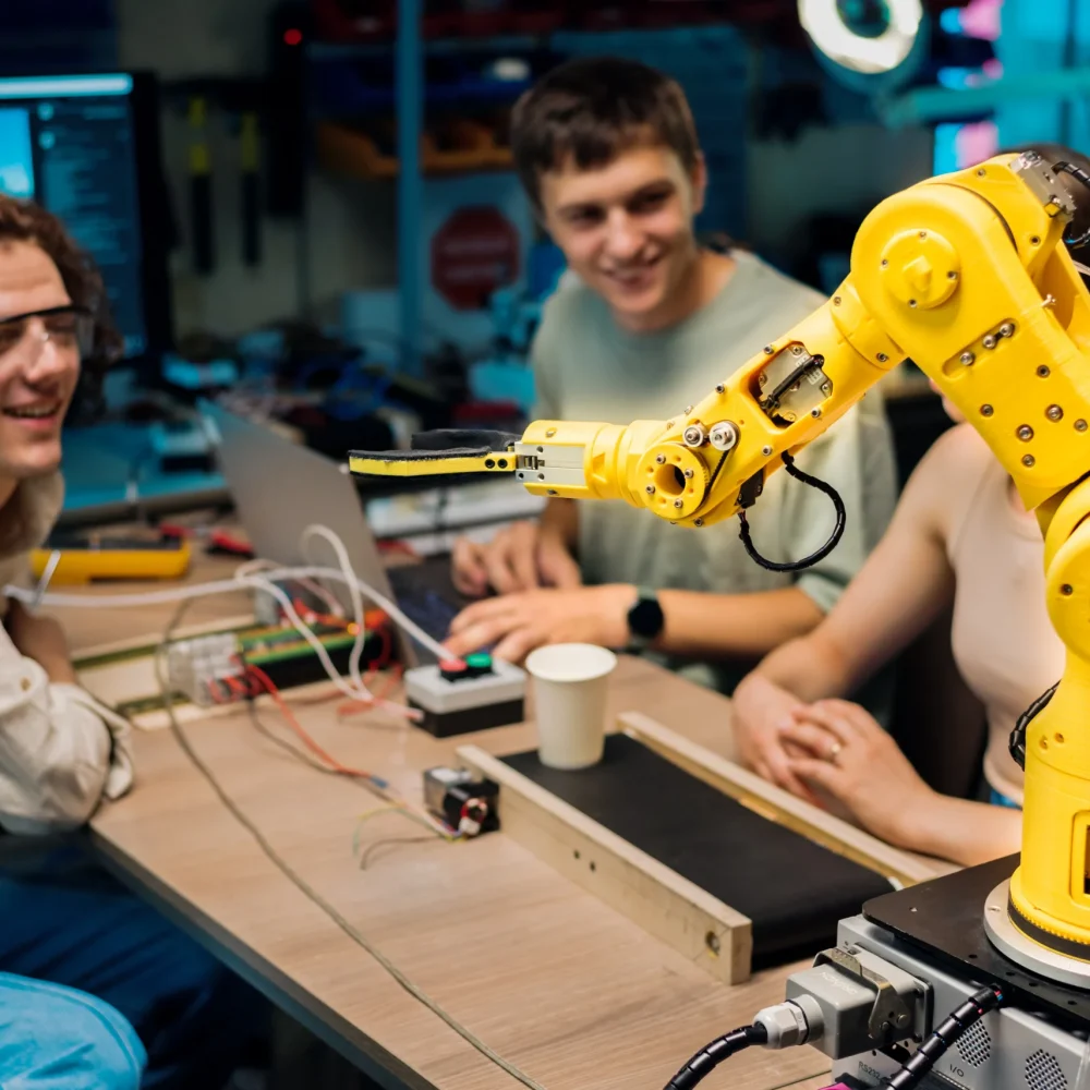 Technical design team at Pixerts performing UX research and programming on a collaborative robotic arm.