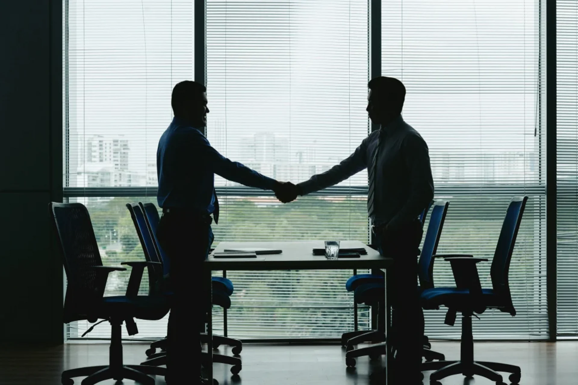Professional handshake silhouette representing the client onboarding process at Pixerts B2B agency.
